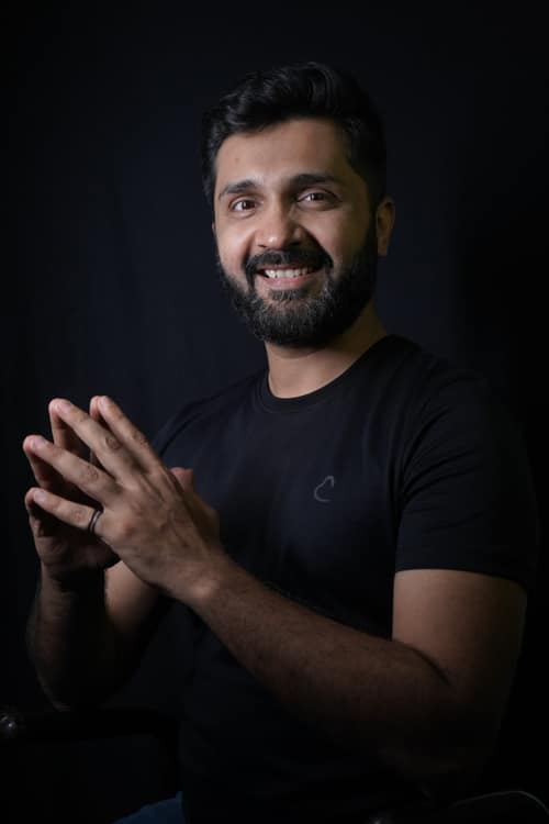 Alok Vasavda, hands together, photographed against a dark background